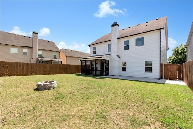 4171 Towncastle Ln, Buford, GA 30518 - back of house with a sunroom, an outdoor fire pit, a patio, and a chimney