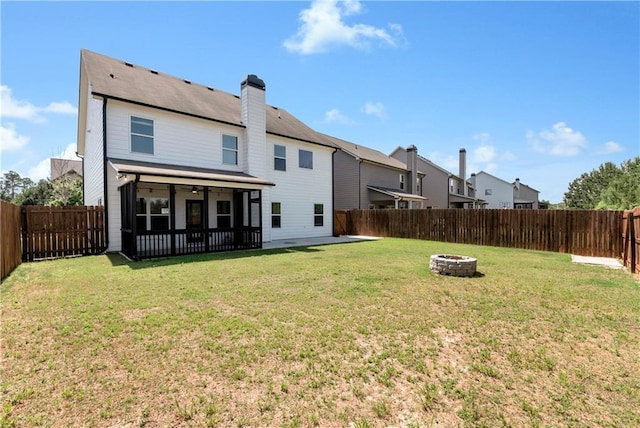 4171 Towncastle Ln, Buford, GA 30518 - rear view of house featuring an outdoor fire pit, ceiling fan, a patio area, a chimney, and a sunroom