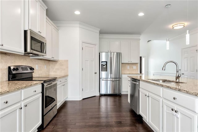 4171 Towncastle Ln, Buford, GA 30518 - kitchen featuring appliances with stainless steel finishes, a sink, white cabinetry, tasteful backsplash, and light stone countertops
