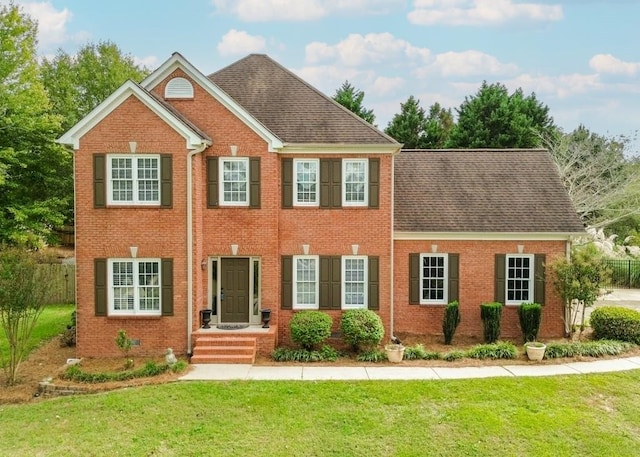 colonial-style house with a front lawn