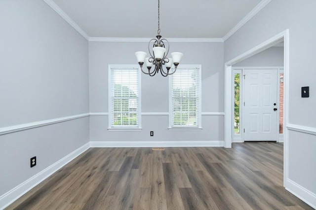 unfurnished dining area with crown molding, an inviting chandelier, and dark wood-type flooring