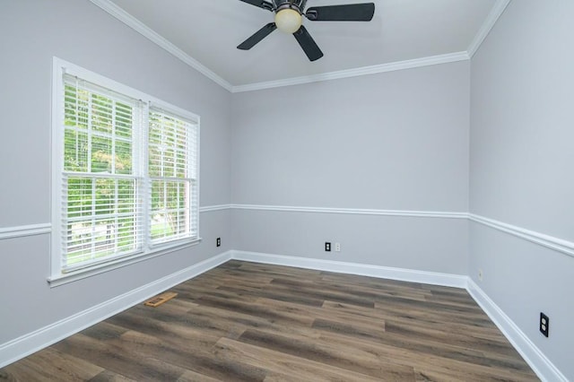 spare room with plenty of natural light, dark hardwood / wood-style flooring, and crown molding