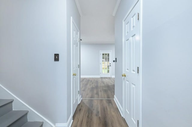 hall with hardwood / wood-style flooring and ornamental molding