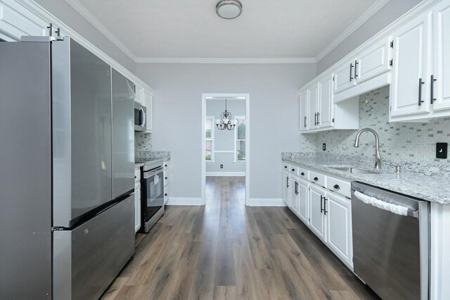 kitchen with sink, white cabinetry, appliances with stainless steel finishes, dark hardwood / wood-style floors, and light stone countertops