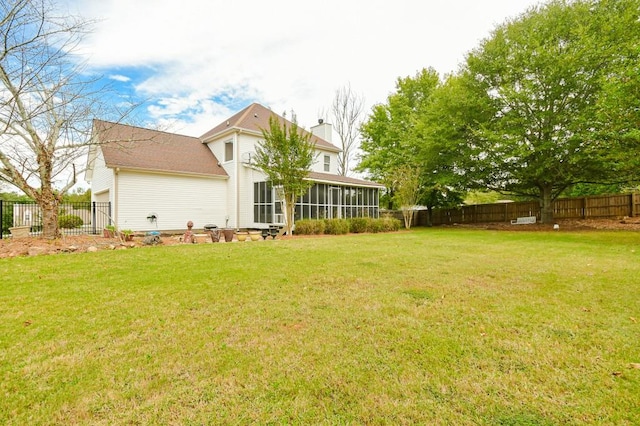 back of house with a yard and a sunroom