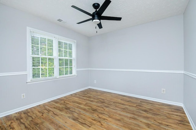 unfurnished room with a textured ceiling, hardwood / wood-style floors, and ceiling fan