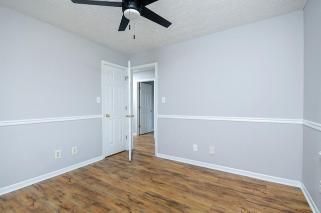 unfurnished room featuring a textured ceiling, ceiling fan, and hardwood / wood-style flooring