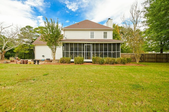 back of house with a yard and a sunroom