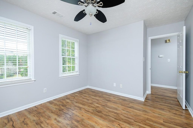 spare room with a textured ceiling, hardwood / wood-style floors, and ceiling fan