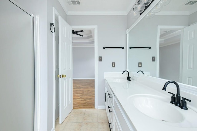 bathroom featuring crown molding, tile patterned flooring, and vanity