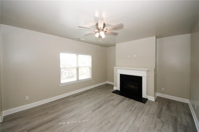 unfurnished living room featuring ceiling fan and wood-type flooring