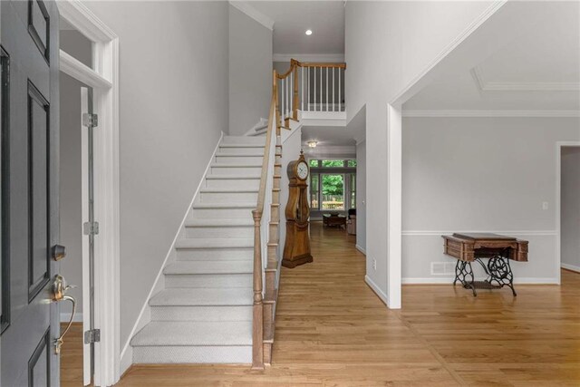 2026 Cresthaven Walk, Woodstock, GA 30189 - entryway with light wood-style floors, stairs, crown molding, baseboards, and recessed lighting
