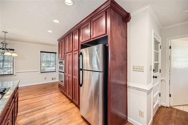 kitchen with stainless steel appliances, light stone counters, light hardwood / wood-style floors, hanging light fixtures, and crown molding