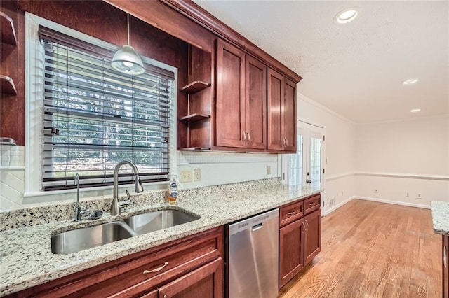 kitchen with ornamental molding, light stone countertops, dishwasher, and sink