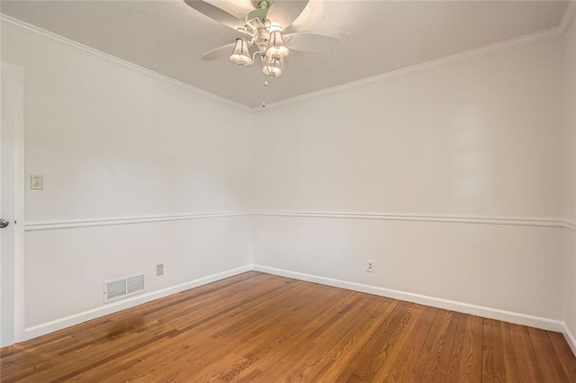 empty room with wood-type flooring, ceiling fan, and crown molding