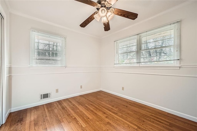 unfurnished room with ceiling fan, hardwood / wood-style flooring, and ornamental molding