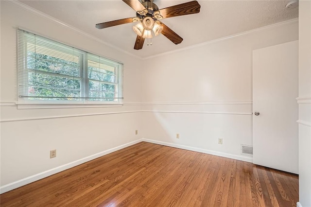 unfurnished room with ceiling fan, hardwood / wood-style flooring, and crown molding