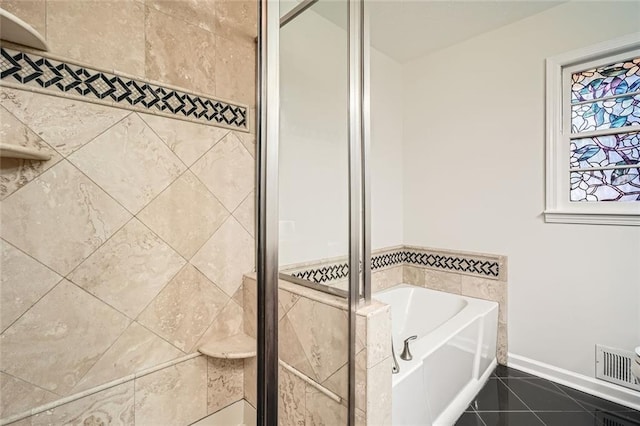 bathroom with tile patterned flooring and shower with separate bathtub