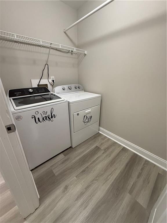 washroom with light wood-type flooring and separate washer and dryer