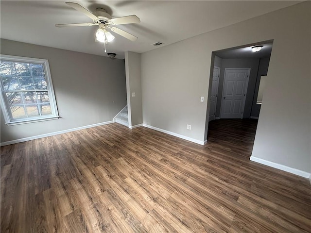 empty room with ceiling fan and dark hardwood / wood-style floors