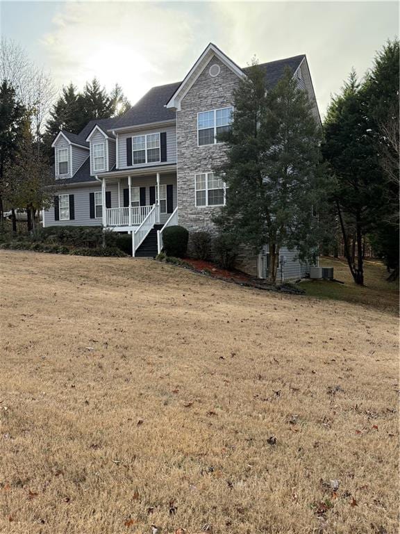 front of property with covered porch and a front lawn