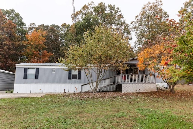 exterior space featuring a front lawn and a deck