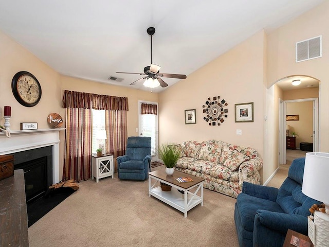 living room featuring light carpet, ceiling fan, and lofted ceiling