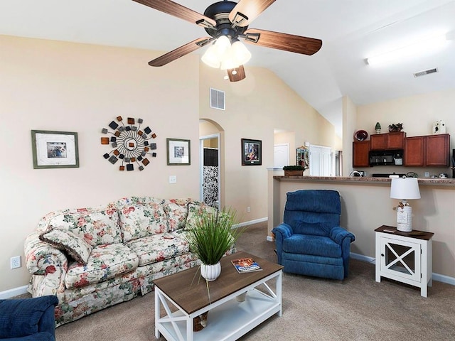 living room with ceiling fan, lofted ceiling, and light carpet