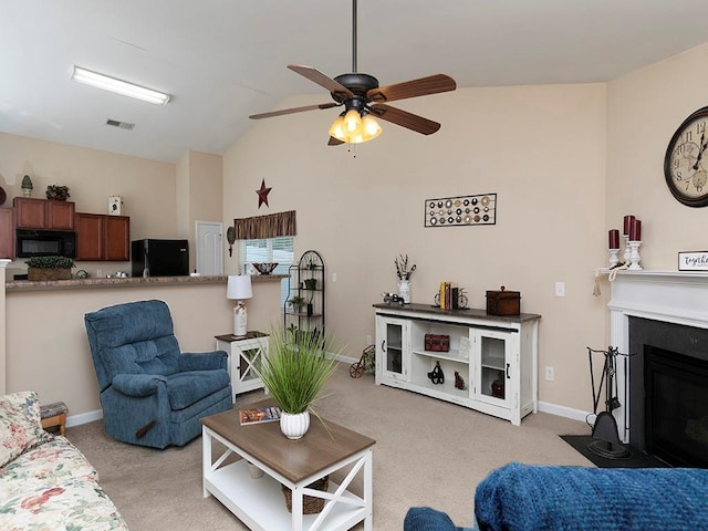 living room with ceiling fan, light colored carpet, and lofted ceiling