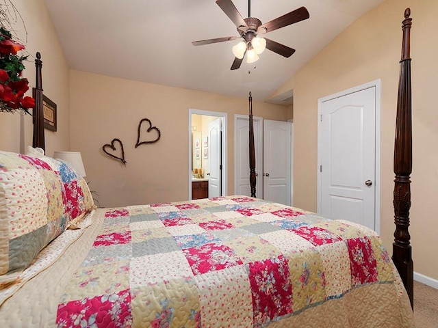 carpeted bedroom featuring connected bathroom, ceiling fan, and vaulted ceiling