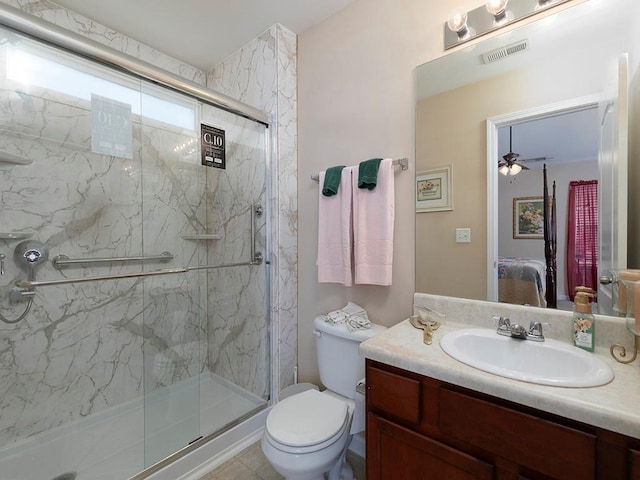 bathroom with ceiling fan, vanity, an enclosed shower, and toilet