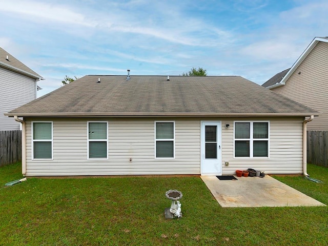 back of house featuring a yard and a patio area