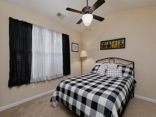 carpeted bedroom with multiple windows, vaulted ceiling, and ceiling fan