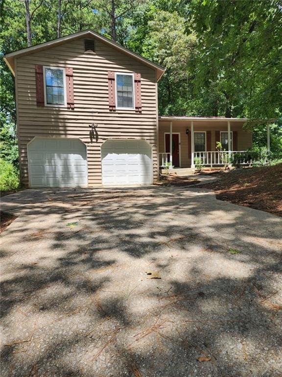 5389 Martins Crossing Rd, Stone Mountain, GA 30088 - view of side of home with covered porch, driveway, and an attached garage