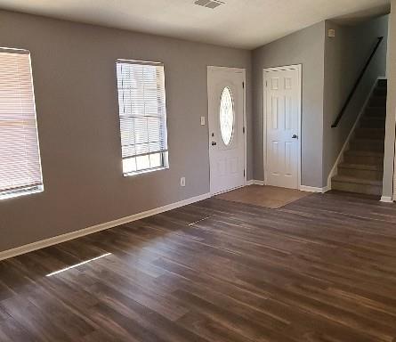 5389 Martins Crossing Rd, Stone Mountain, GA 30088 - foyer with dark wood-type flooring, baseboards, and stairway