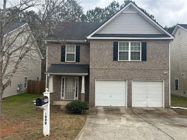 view of front of home with a garage and a front lawn