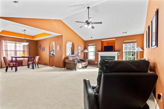 carpeted living room featuring ceiling fan and lofted ceiling