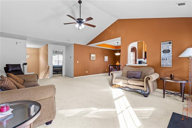 living room featuring carpet flooring, ceiling fan, and vaulted ceiling