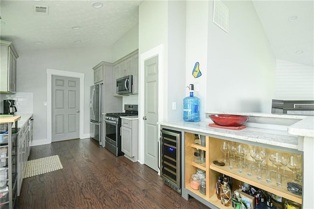 787 Mckendree Lake Way, Lawrenceville, GA 30043 - kitchen with stainless steel appliances, wine cooler, lofted ceiling, dark wood-type flooring, and gray cabinets