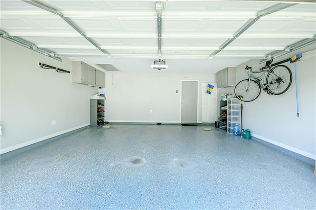 787 Mckendree Lake Way, Lawrenceville, GA 30043 - garage featuring baseboards and a garage door opener