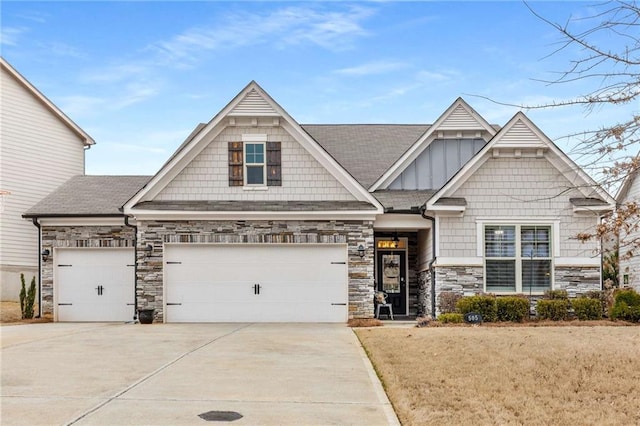 craftsman-style house with driveway, board and batten siding, stone siding, and roof with shingles