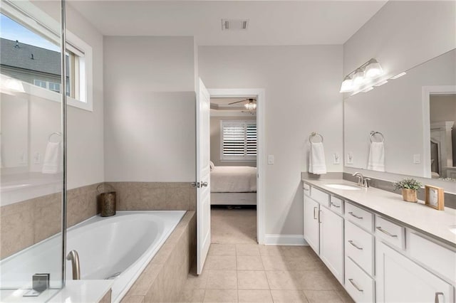 ensuite bathroom with ensuite bathroom, a garden tub, tile patterned flooring, a sink, and visible vents