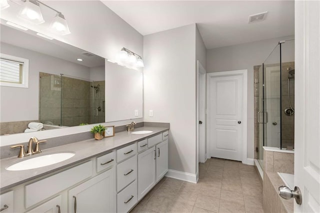 full bathroom with a stall shower, visible vents, and a sink