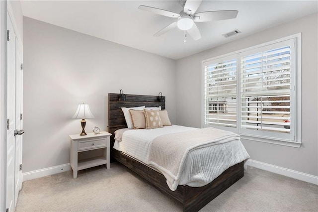 bedroom featuring baseboards, a ceiling fan, visible vents, and light colored carpet