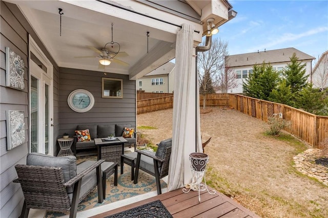 view of patio with a fenced backyard, an outdoor hangout area, and a ceiling fan