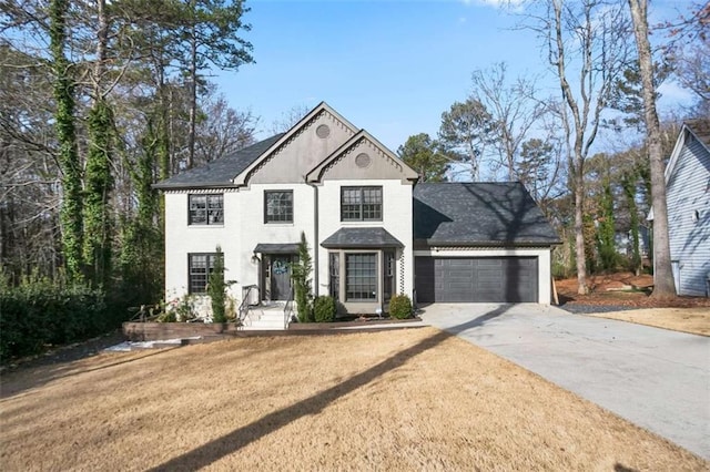 view of front of home with a front yard and a garage