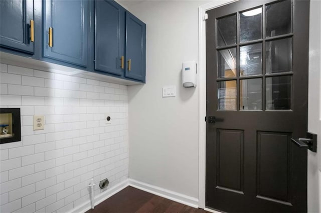 clothes washing area featuring dark hardwood / wood-style floors, hookup for a washing machine, and cabinets