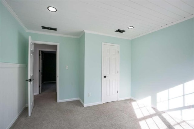 unfurnished bedroom featuring light colored carpet and ornamental molding