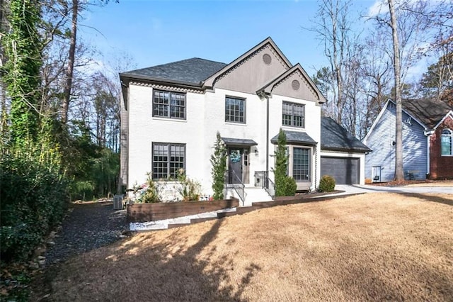 view of front of house with a front lawn and a garage