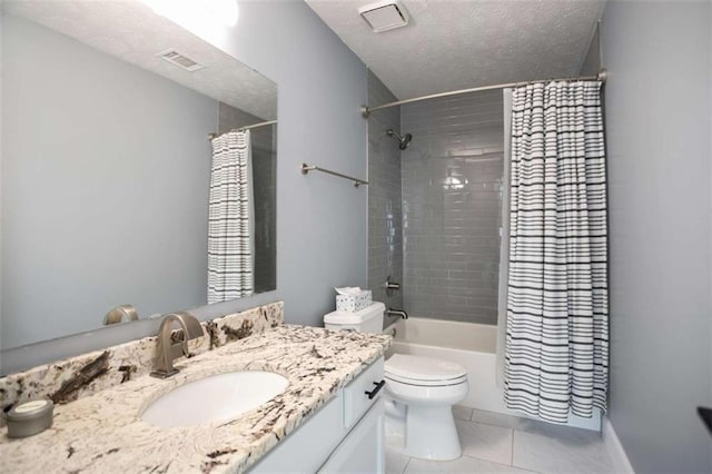 full bathroom with toilet, vanity, tile patterned flooring, shower / tub combo, and a textured ceiling